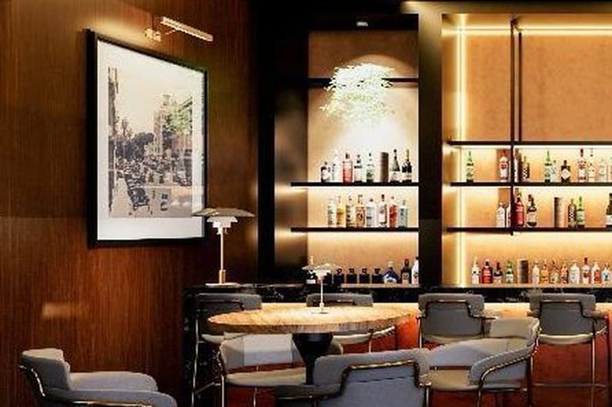 Artist’s impression of a panelled bar with lit bottle shelves, high tables and stools.