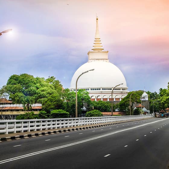 Photograph of the white stupa of the Kalutara Bodhiya above the river mouth.